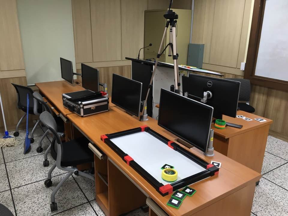 The second platform in a teaching lab: the arena on a desk between computer workstations, with the camera on a tripod.